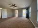 Large bedroom with neutral walls, ceiling fan, and doorway to balcony, creating a comfortable and inviting space at 493 Emerson Dr., Myrtle Beach, SC 29579