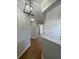 Inviting hallway with wood floors and stylish light fixture leading to an open living space at 493 Emerson Dr., Myrtle Beach, SC 29579