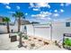 Charming backyard oasis featuring a white fence, palm trees, and unique stone accents at 5013 Sassari St., Myrtle Beach, SC 29579