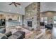 Spacious common area with a stone fireplace, kitchen, and comfortable seating at 5013 Sassari St., Myrtle Beach, SC 29579