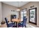 Charming dining area featuring a wooden table, blue chairs, and a bright window with outdoor views at 5013 Sassari St., Myrtle Beach, SC 29579