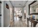 Open hallway with light wood flooring, leading to the living spaces and staircase at 5013 Sassari St., Myrtle Beach, SC 29579