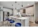 Spacious kitchen featuring white cabinets, a large island with bar stools, and stainless appliances at 5013 Sassari St., Myrtle Beach, SC 29579