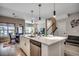 Open-concept kitchen with a large island, stainless steel appliances, and pendant lighting at 5013 Sassari St., Myrtle Beach, SC 29579