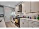 Well-lit kitchen with white cabinets, stainless steel appliances, and modern countertops at 5013 Sassari St., Myrtle Beach, SC 29579