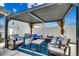 A covered patio features comfortable seating around a central coffee table at 5013 Sassari St., Myrtle Beach, SC 29579