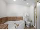 Bathroom featuring a luxurious jacuzzi tub, toilet, and glass-enclosed shower at 5310 N Ocean Blvd. # Ph 6 1506, Myrtle Beach, SC 29577
