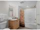 Well-lit bathroom with a vanity, granite countertop, a mirror, and a shower-tub combo with a palm tree shower curtain at 5310 N Ocean Blvd. # Ph 6 1506, Myrtle Beach, SC 29577