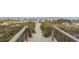 Sandy path to the beach with wooden stairs, natural dunes, and ocean views, provides easy access to the sea at 5310 N Ocean Blvd. # Ph 6 1506, Myrtle Beach, SC 29577