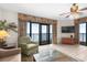 The living room with a ceiling fan has access to a balcony with ocean views at 5310 N Ocean Blvd. # Ph 6 1506, Myrtle Beach, SC 29577