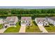 Aerial view of a beautiful white home near a serene pond and lush greenery at 560 Pier Ct., Longs, SC 29568