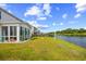 Lush backyard with screened in porch overlooking a serene lake at 560 Pier Ct., Longs, SC 29568