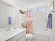 Bright bathroom featuring a white vanity, tub with shower, and decorative accents at 560 Pier Ct., Longs, SC 29568