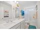 Bright bathroom with a double vanity, tub with shower, and colorful decor at 560 Pier Ct., Longs, SC 29568
