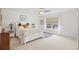 Bright bedroom with a ceiling fan, large window, and neutral carpet at 560 Pier Ct., Longs, SC 29568