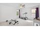 Home gym with treadmill, rowing machine, ceiling fan, and lake views at 560 Pier Ct., Longs, SC 29568