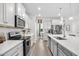 Modern kitchen showcases stainless steel appliances, granite countertops, and ample storage space at 560 Pier Ct., Longs, SC 29568