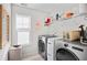 Well-lit laundry room featuring modern washer and dryer units at 560 Pier Ct., Longs, SC 29568