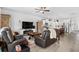 Bright, open-concept living room with hardwood floors, comfortable seating, and a modern ceiling fan at 560 Pier Ct., Longs, SC 29568