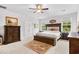 Serene main bedroom with a large bed, dark wood furniture, a decorative rug, and bright natural light at 560 Pier Ct., Longs, SC 29568
