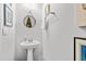Elegant powder room featuring a pedestal sink, decorative mirror, and soft lighting at 560 Pier Ct., Longs, SC 29568