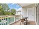 Relaxing outdoor balcony with pond view, seating, and access to a storage closet at 5825 Catalina Dr. # 523, North Myrtle Beach, SC 29582
