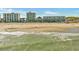Wide sandy beach with ocean waves, beachside condos, and people enjoying the sunny day at 5825 Catalina Dr. # 523, North Myrtle Beach, SC 29582