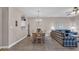 Cozy dining area features a wooden table, chandelier, and blends into a comfortable living space at 5825 Catalina Dr. # 523, North Myrtle Beach, SC 29582