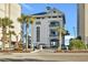 Coastal multi-story building with an elevator and palm trees, near the beach and amenities at 5825 Catalina Dr. # 523, North Myrtle Beach, SC 29582