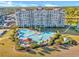Stunning aerial view of high-rise condo building featuring a pool and lush landscaping at 5825 Catalina Dr. # 523, North Myrtle Beach, SC 29582