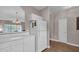 Open kitchen featuring white cabinets and modern appliances, seamlessly connecting to the dining area at 5825 Catalina Dr. # 523, North Myrtle Beach, SC 29582