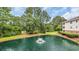 Scenic pond with a fountain, surrounded by lush landscaping and mature trees at 5825 Catalina Dr. # 523, North Myrtle Beach, SC 29582