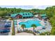 Aerial view of a community pool area with pool house, lounge chairs, and lush landscaping at 5825 Catalina Dr. # 523, North Myrtle Beach, SC 29582