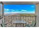 Enjoy an ocean view from the balcony with a table and chairs overlooking the coastline at 5905 S Kings Highway # 1106, Myrtle Beach, SC 29575