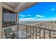 This balcony view includes a table and chairs, overlooking the beach and the scenic coastline at 5905 S Kings Highway # 1106, Myrtle Beach, SC 29575