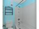 Bathroom featuring light blue walls, a toilet, and a shower with a tub and white vinyl surround at 5905 S Kings Highway # 1106, Myrtle Beach, SC 29575