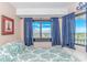 Cozy bedroom with a view and patterned bed at 5905 S Kings Highway # 1106, Myrtle Beach, SC 29575