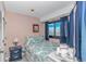 Comfortable bedroom with queen bed, nightstand, and ocean view window at 5905 S Kings Highway # 1106, Myrtle Beach, SC 29575