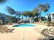 Resort pool with ample lounge chairs surrounded by mature trees and lush landscaping, perfect for relaxation at 5905 S Kings Highway # 1106, Myrtle Beach, SC 29575