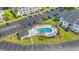 Aerial view of the community pool surrounded by parking and lush landscaping at 6000 Windsor Green Way # 104, Myrtle Beach, SC 29579