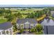 Aerial view of a condo building overlooking a golf course and pond, with ample parking at 6000 Windsor Green Way # 104, Myrtle Beach, SC 29579