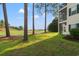 Expansive backyard with lush green lawn and serene views of the surrounding golf course at 6000 Windsor Green Way # 104, Myrtle Beach, SC 29579
