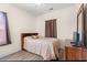 Comfortable bedroom with TV and dresser, wood grain flooring and natural light at 6000 Windsor Green Way # 104, Myrtle Beach, SC 29579