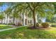 Beautiful condo building with well-maintained landscaping, mature trees, and a pond at 6000 Windsor Green Way # 104, Myrtle Beach, SC 29579