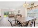 Open-concept living room and dining area featuring wood floors, comfortable seating, and ample natural light at 6000 Windsor Green Way # 104, Myrtle Beach, SC 29579