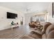 Comfortable living room showcasing wood floors, sofas, a ceiling fan, television and a view of the dining room at 6000 Windsor Green Way # 104, Myrtle Beach, SC 29579