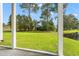 Screened patio overlooking a grassy yard and a tranquil pond, creating a serene outdoor retreat at 6000 Windsor Green Way # 104, Myrtle Beach, SC 29579