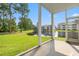 Screened patio with a view of the lake and well-manicured lawn, offering a relaxing outdoor space at 6000 Windsor Green Way # 104, Myrtle Beach, SC 29579