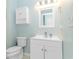 Clean bathroom with a white vanity, toilet, and light blue walls, offering a fresh and simple aesthetic at 6001- 8005 S Kings Hwy., Myrtle Beach, SC 29575