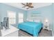 Serene bedroom with a blue bedspread, white furniture, and coastal-themed decor creating a peaceful retreat at 6001- 8005 S Kings Hwy., Myrtle Beach, SC 29575